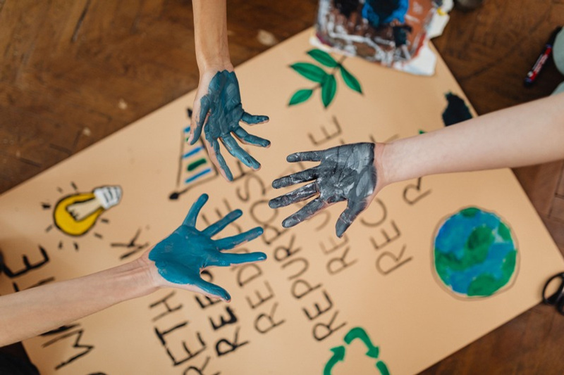 Children creating an environmental awareness poster